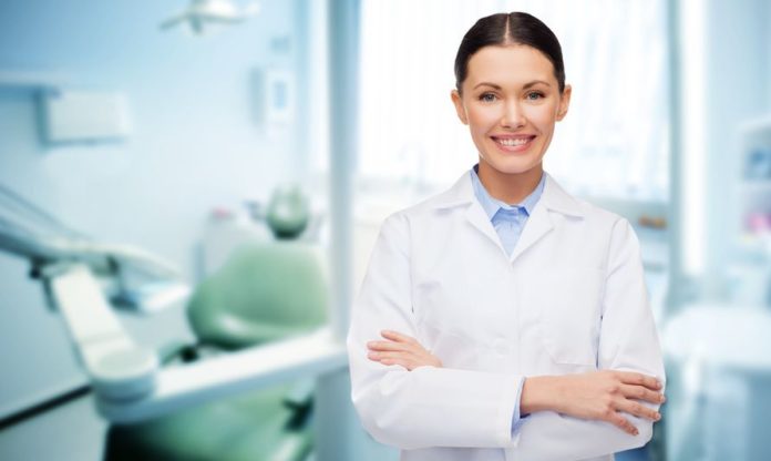 People, Medicine, Stomatology And Healthcare Concept - Happy Young Female Dentist With Tools Over Medical Office Background